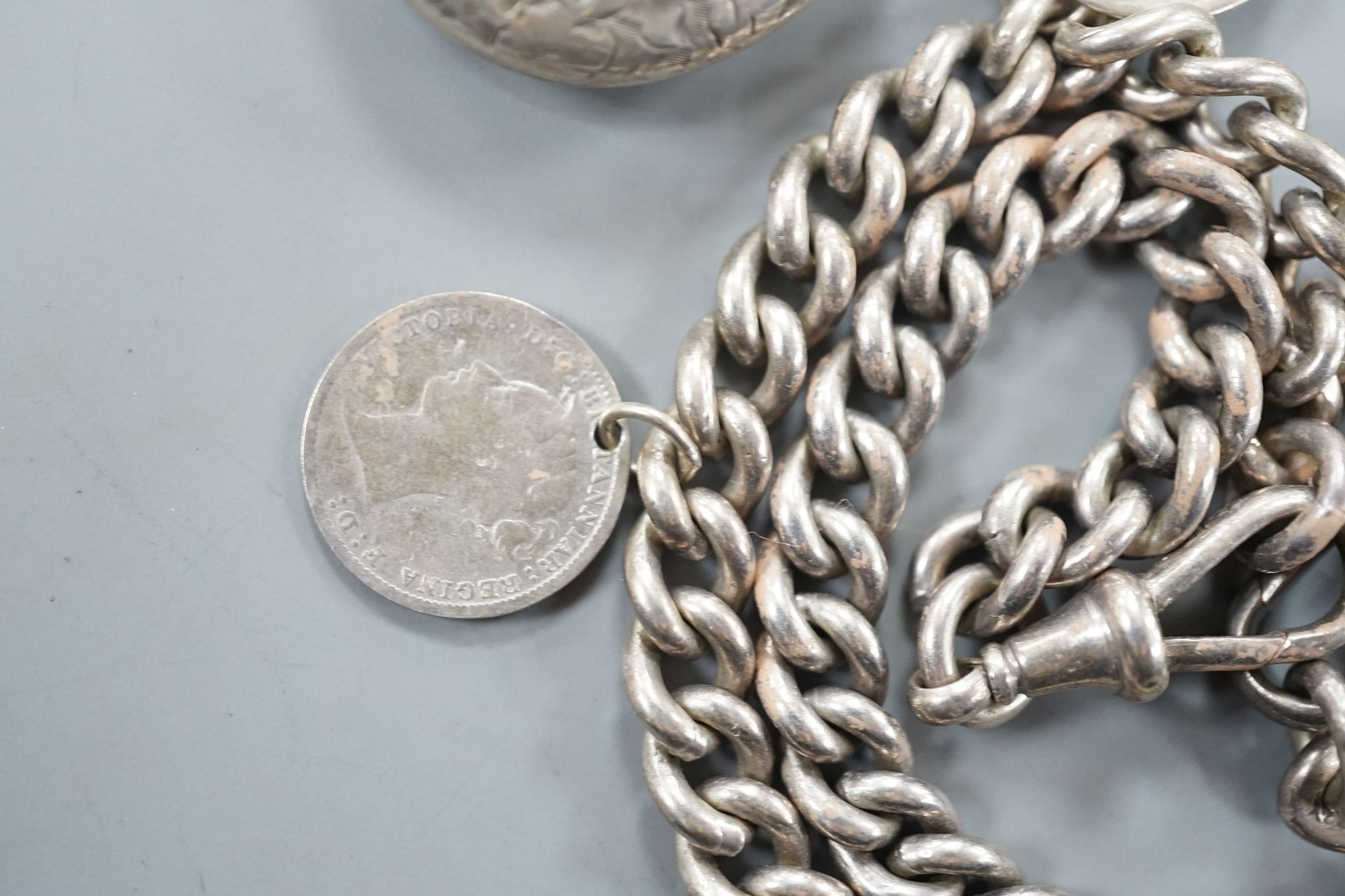 A Middle Eastern yellow metal and gem set pendant, gross 5.9 grams, a silver albert hung with assorted coins and a Victorian silver oval locket.